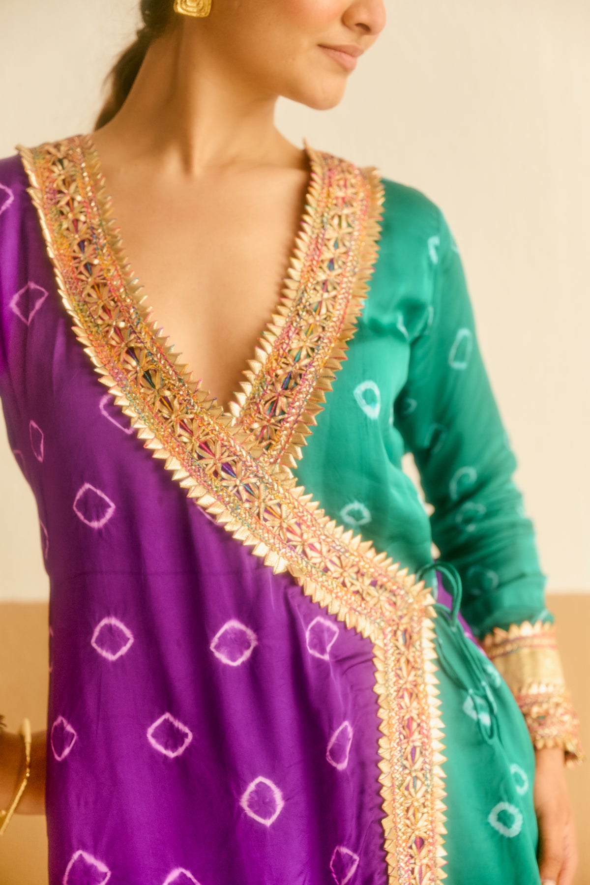Purple and green hand tied and dyed bandhani outfit with intricate gold detailing